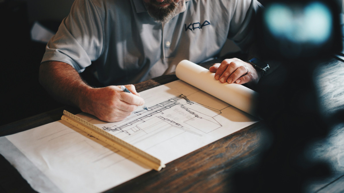 An architect sketches a building plan.